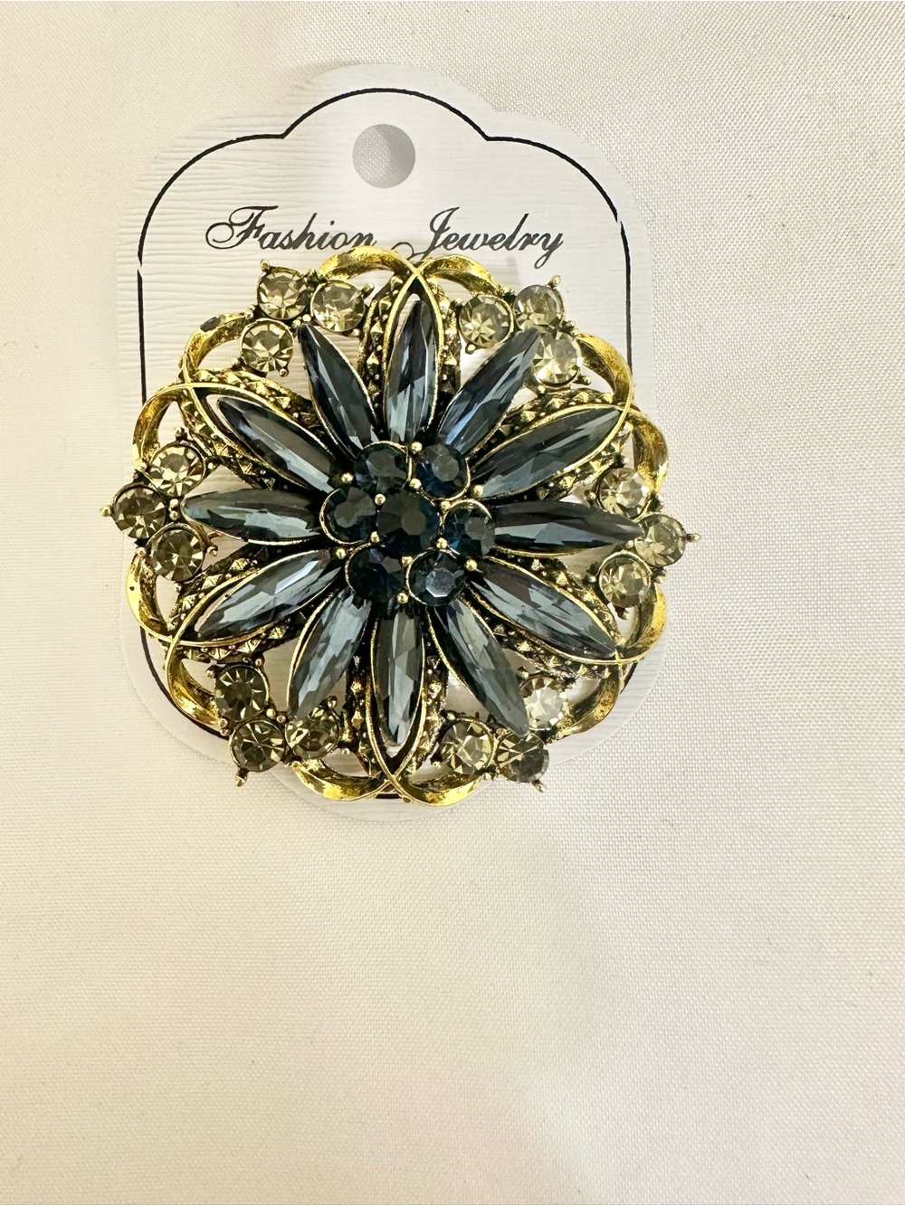 Gold-Tone Brooch with Dark Blue and Light Grey Crystals